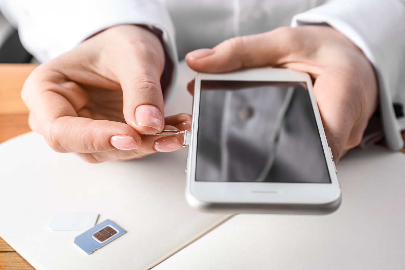 Person Opening a Sim Card Slot 